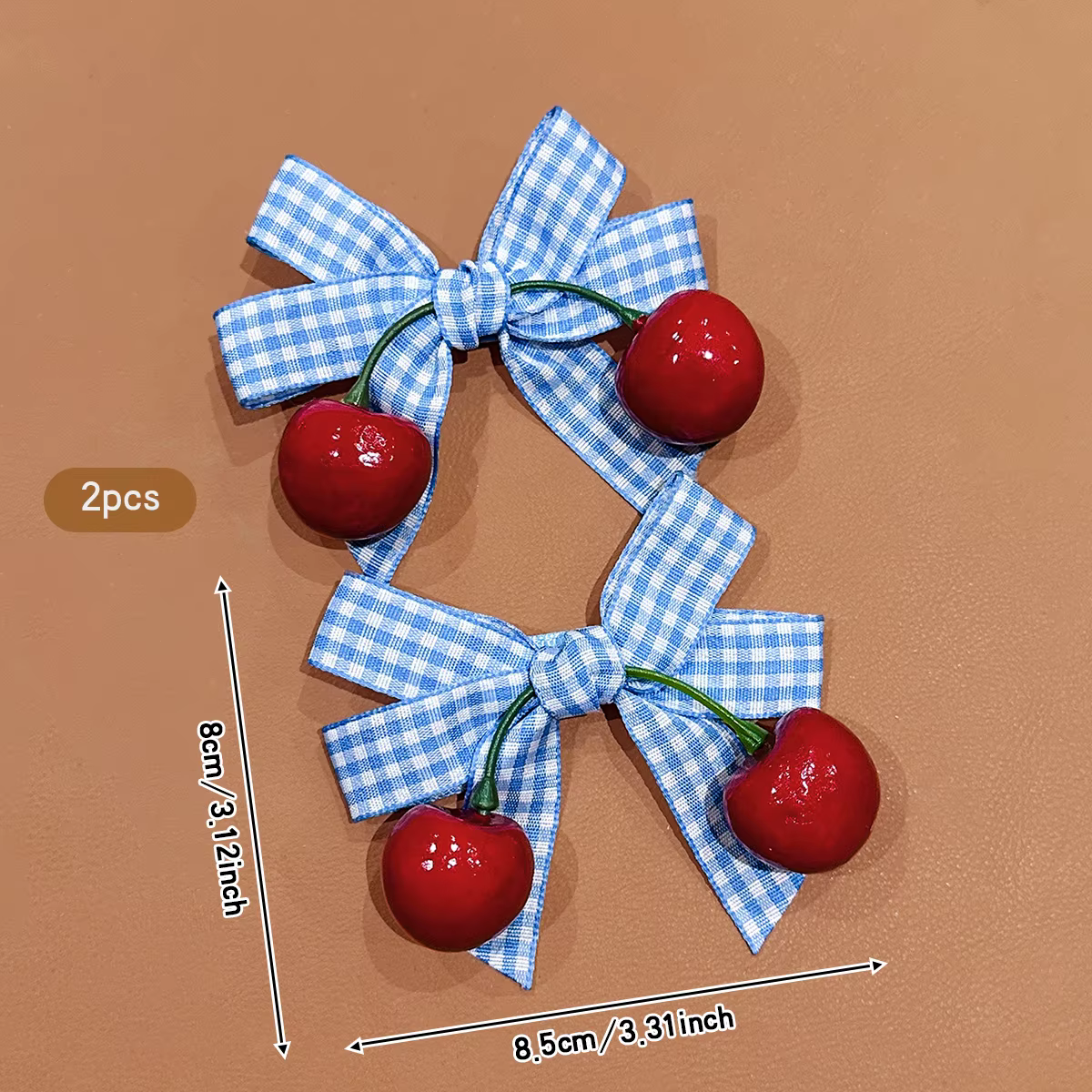 2 pinces à cheveux cerise avec nœud bleu